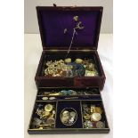 An old jewellery box containing necklaces, brooches, pendants etc.