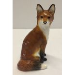 A ceramic John Beswick fox figurine, approx 14cm high. Small chip to paintwork on ears & nose.