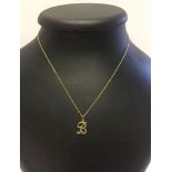 A 9ct gold 'B' pendant on a 9ct gold chain.