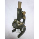An old painted metal monocular microscop