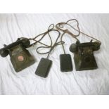 Two old black Bakelite telephones, one m