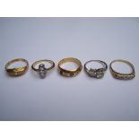 Four 18ct diamond set yellow gold rings and one platinum diamond set crossover ring,