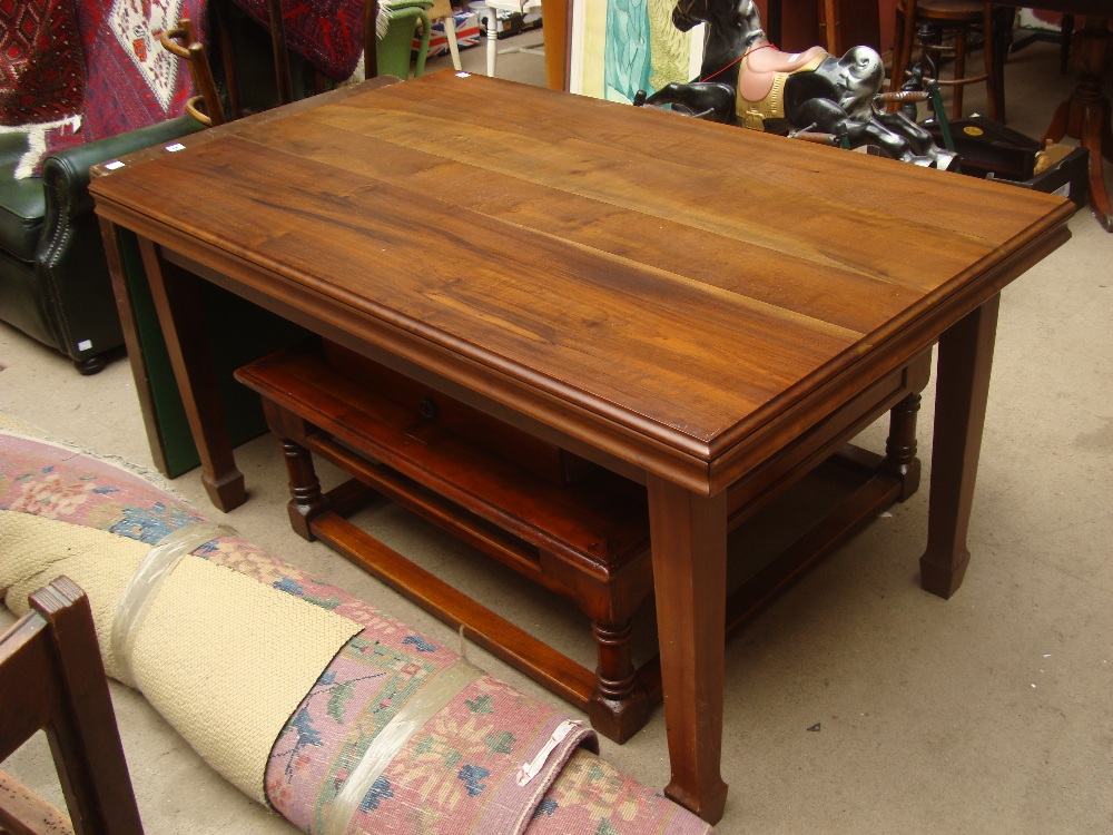 An African hardwood dining table on square legs with spade feet. 150 x 90cm.