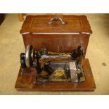 An inlaid cased Singer sewing machine.