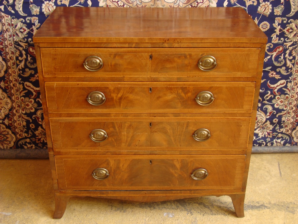 An early 19th Century mahogany chest of drawers on splayed bracket feet, with four long drawers.