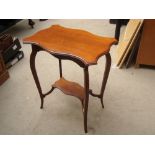 An Edwardian mahogany occasional table, with cabriole legs united by a raised undertier.