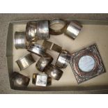 Four silver napkin rings and nine white metal napkin rings with an Art Nouveau photograph frame.