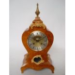 Peter Spicer: A Lousi XV style burr mulberry mantle clock, of bombe form,