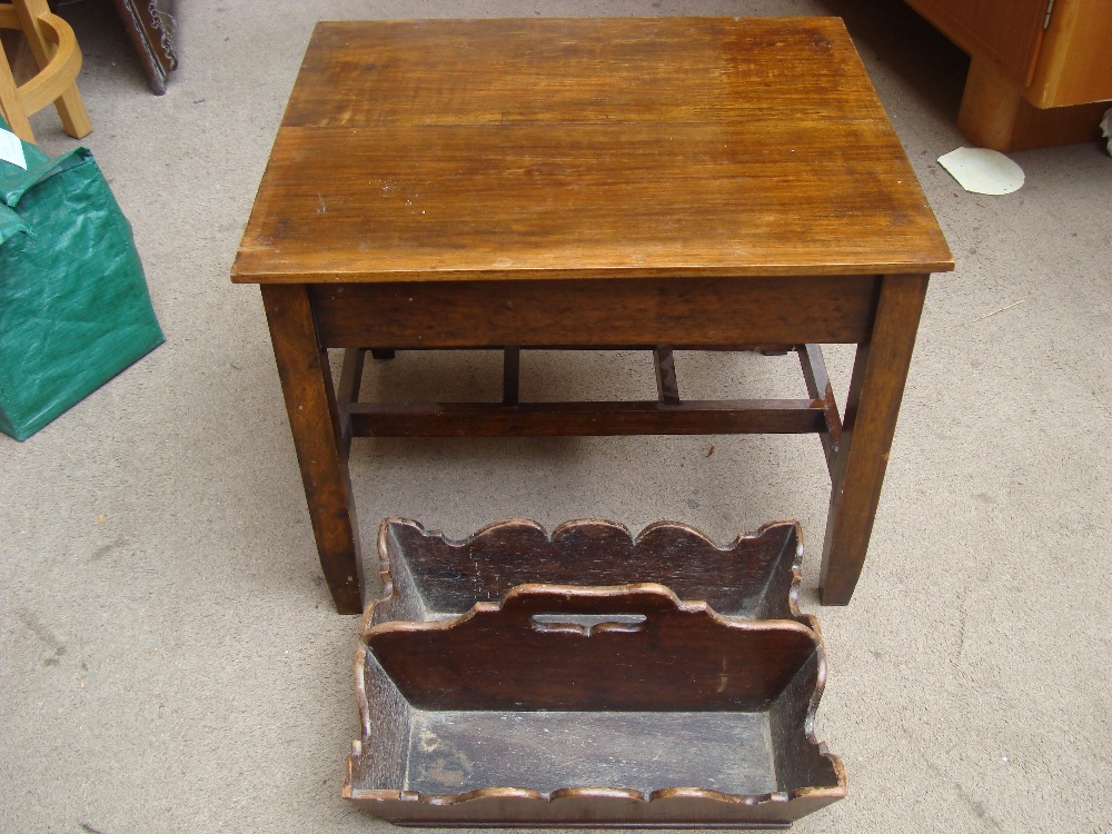 A low mahogany table with a 19th Century cutlery carrier.