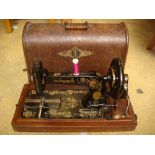 A Singer sewing machine in wooden case.