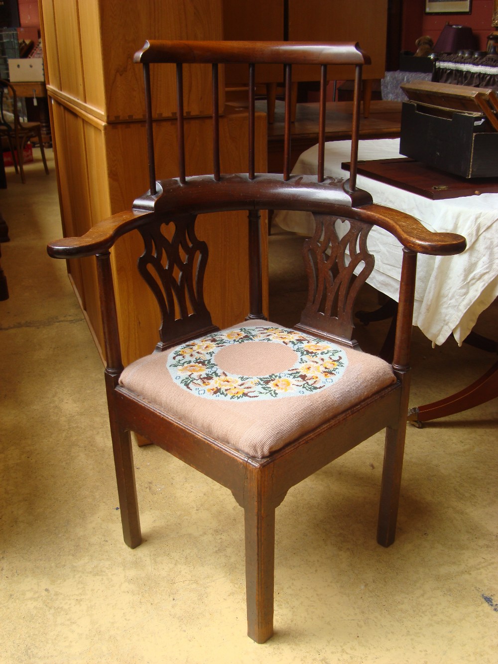 A George III corner chair with outswept arms,