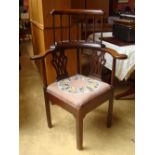A George III corner chair with outswept arms,