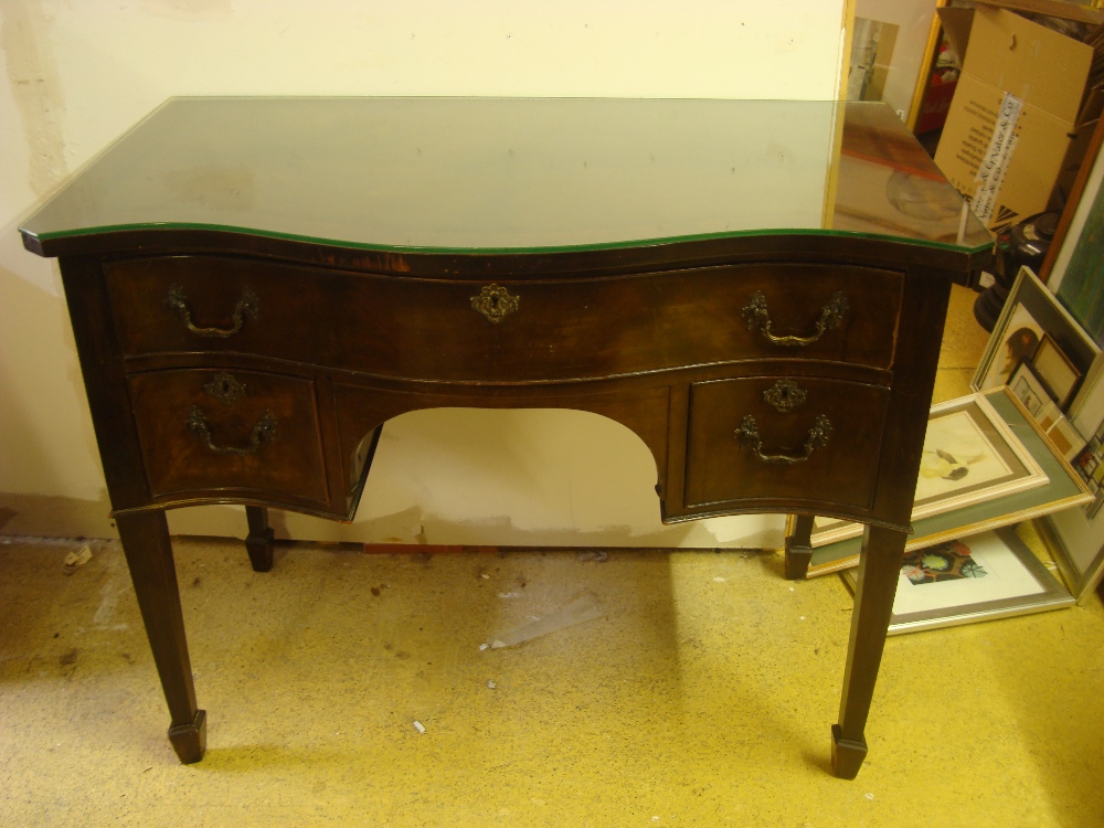 A George III style mahogany serpentine fronted dressing table,