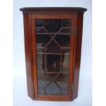 A George III mahogany hanging corner cabinet,