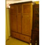 A 1930's double wardrobe, with two doors over two short drawers.