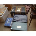A small wooden bound trunk and three other suitcases.