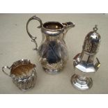 A silver jug (a/f), sifter (white metal) and an embossed milk jug.