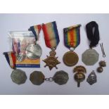 A small selection of medals and badges to include Victory medal and 1914-15 Star, both to Private W.