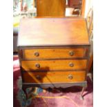 An Edwardian mahogany fall front bureau, with fitted interior over three graduated drawers,
