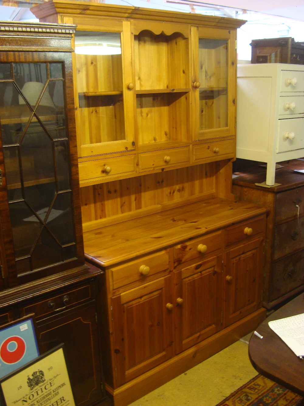 A modern pine dresser, the base with three short drawers over three cupboard drawers,