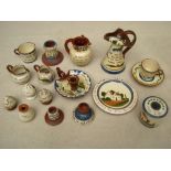 Seventeen pieces of Motto ware including puzzle jug and candlesticks.