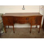 A George III style mahogany serpentine sideboard ,