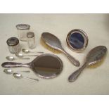 A silver photograph frame, silver coffee spoons, a silver backed dressing table set.