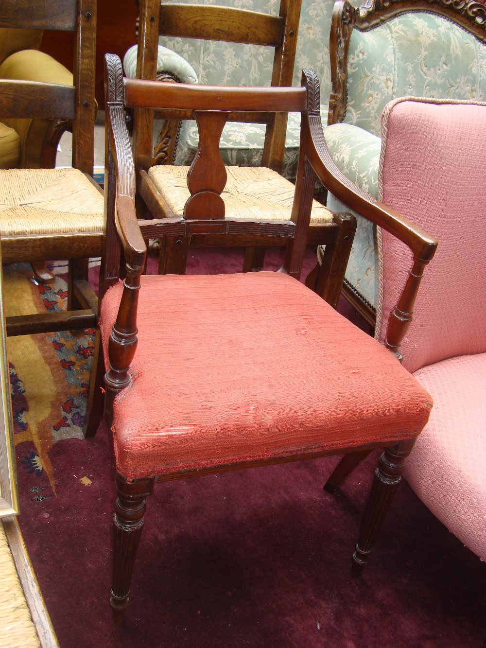 A George III Sheraton type mahogany elbow chair,