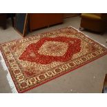 A red ground Qum style carpet. 230 x 160cm.