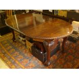 An Edwardian mahogany oval extending dining table,