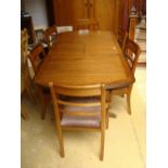 A Waring and Gilllow extending mahogany dining table and six associated chairs.