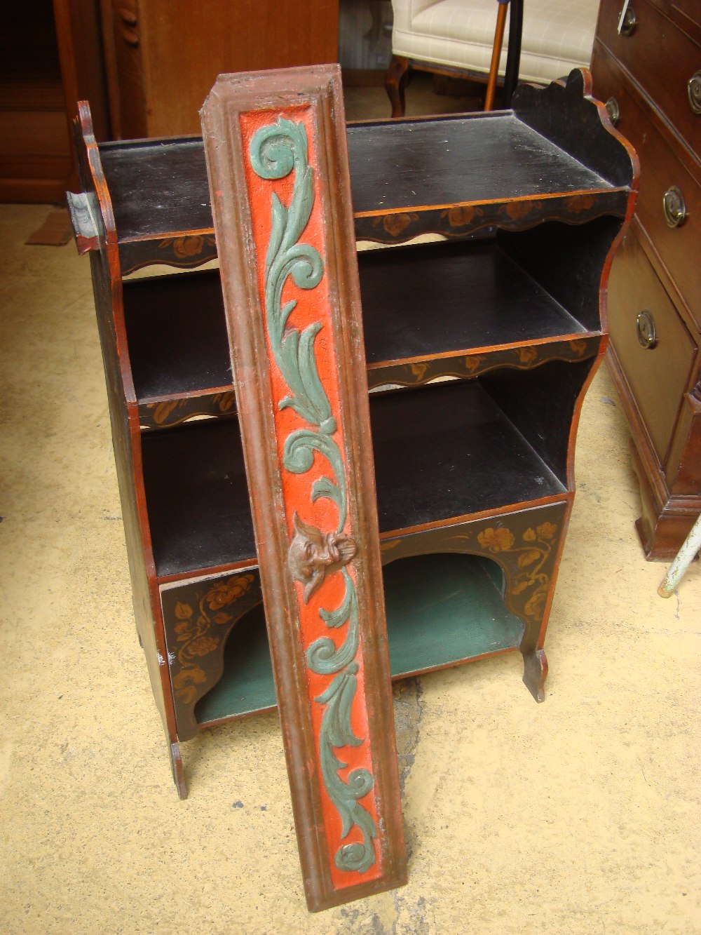 A small arrangement of painted shelves with a painted cased wooden panel.