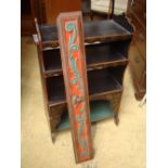 A small arrangement of painted shelves with a painted cased wooden panel.