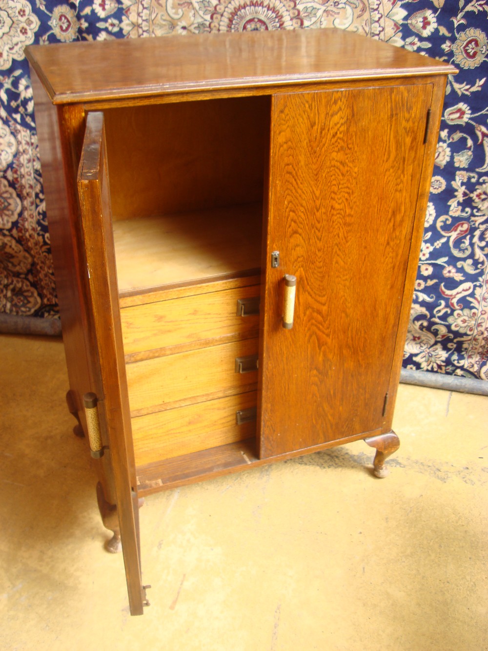 A 1940s oak lowboy, with three drawers to interior.