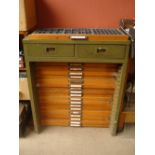 A printers industrial set of drawers with compartments, lead type and instruments etc.