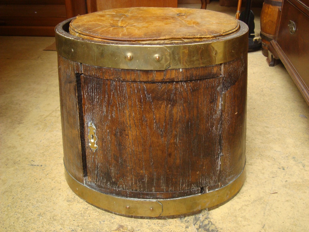 A part 19th Century brass bound barrel converted to a stool with cupboard.