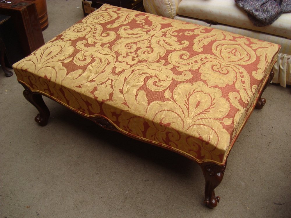 A large 20th Century upholstered cabriole legged footstool.