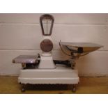 A set of 1950s Avery shop scales, white enamelled with stainless steel trays.