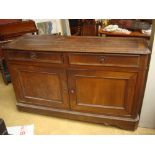 A 19th Century French oak sideboard, with two short drawers over two cupboard doors.