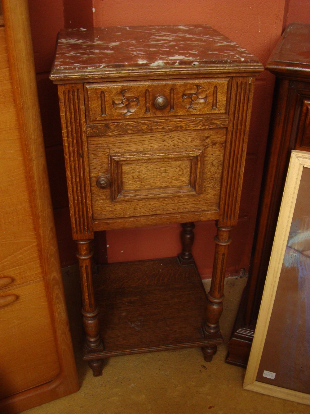 An early 20th Century oak marble topped bedside cabinet/pot cupboard.