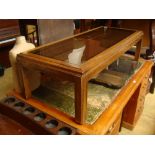 A low coffee table with inset glass top.