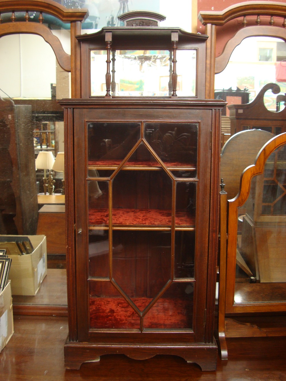 An astragal glazed cupboard with raised gallery.