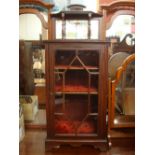 An astragal glazed cupboard with raised gallery.