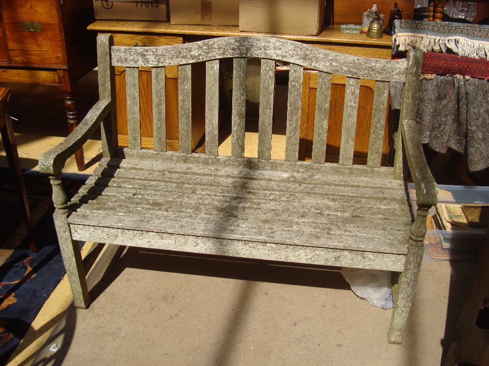 A small pleasantly lichened garden bench.
