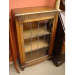 A 1930's glass fronted bookcase.