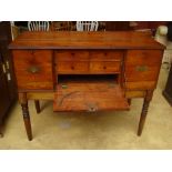 An early 19th Century secretaire, the fall front concealing four drawers over an aperture,