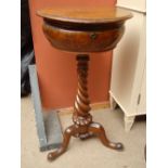 A 19th Century sewing box/work table, the circular top raised on a heavy twisted stem.