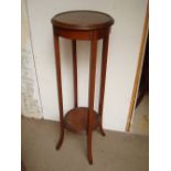 An Edwardian mahogany stand with outswept feet.