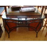 A wrought iron and glass console.