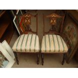 A pair of inlaid Edwardian side chairs.